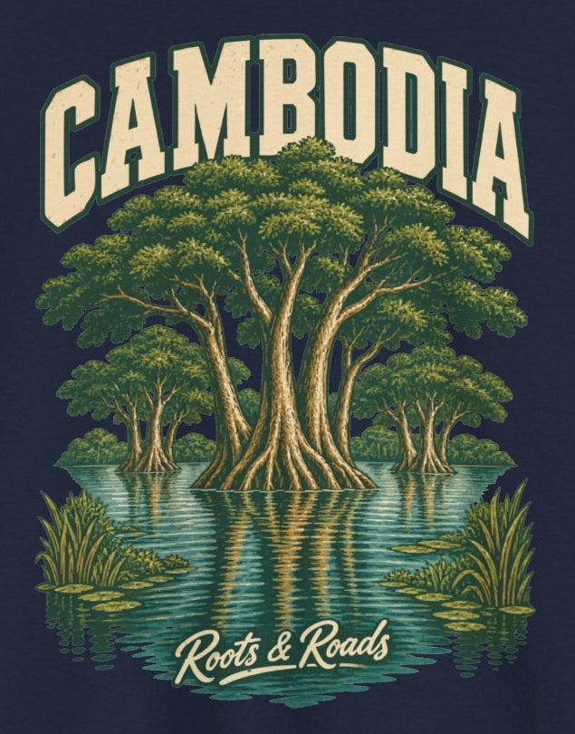 Print detail on Navy cotton showing CAMBODIA lettering, a broad-canopied tree and smaller flooded trees reflected in teal water, with Roots & Roads script.