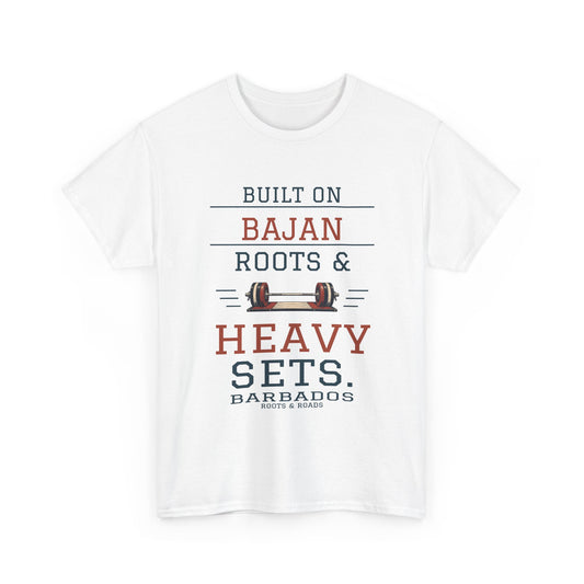 White Barbados Heavy Sets Gym T-Shirt, front print reading “Built on Bajan roots & heavy sets.” with a barbell illustration, Barbados and Roots & Roads lettering.