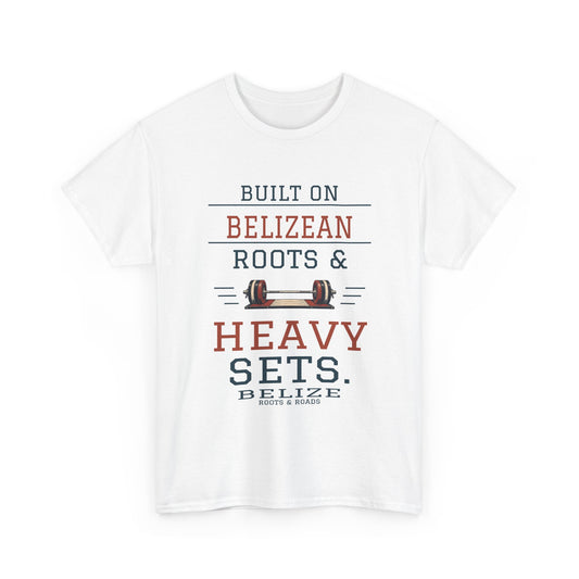 Belize Heavy Sets Gym T-Shirt in White — front print reads “Built on Belizean roots & heavy sets.” with barbell artwork, Belize and Roots & Roads signature.
