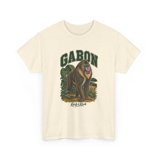 Front view of a Natural Gildan 5000 T-shirt with green GABON lettering above a mandrill with blue-and-red facial markings, forest leaves and grasses, finished with Roots & Roads script.