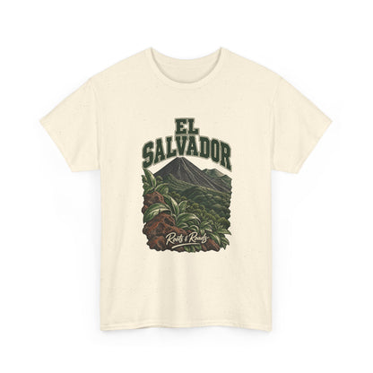 Front view of a Natural Gildan 5000 T-shirt with green two-line EL SALVADOR lettering above a forested volcanic cone, broad leaves and warm lava rocks, finished with Roots & Roads script.