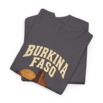 Folded Charcoal Burkina Faso Fresh Prints T-shirt showing two-line cream country lettering above an ochre sun and red-brown stone walls.