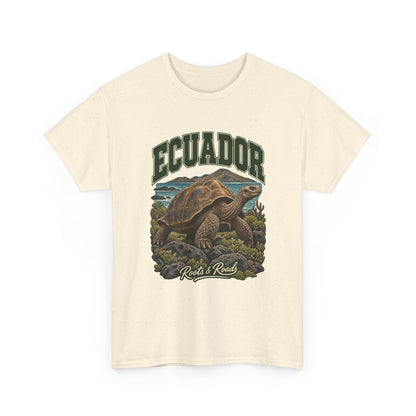 Front view of a Natural Gildan 5000 T-shirt with green ECUADOR lettering above a giant tortoise, volcanic rocks, low plants and coastal water, finished with Roots & Roads script.