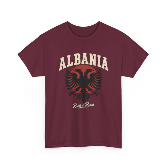 Front view of the Roots & Roads Albania Fresh Prints Gildan 5000 T-shirt in Maroon, with cream arched lettering, a black double-headed eagle and muted red circular accent.