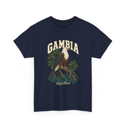 Front view of a Navy Gildan 5000 T-shirt with cream GAMBIA lettering above a white-headed fish eagle, mangrove roots and still water, finished with Roots & Roads script.