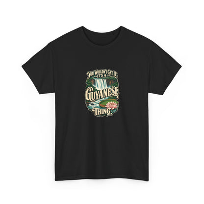 Guyana Guyanese Thing T-shirt in Black, shaped front view; cream vintage sign-painted lettering with a waterfall and tropical water lily and the quote “You wouldn’t get it. It’s a Guyanese thing.”