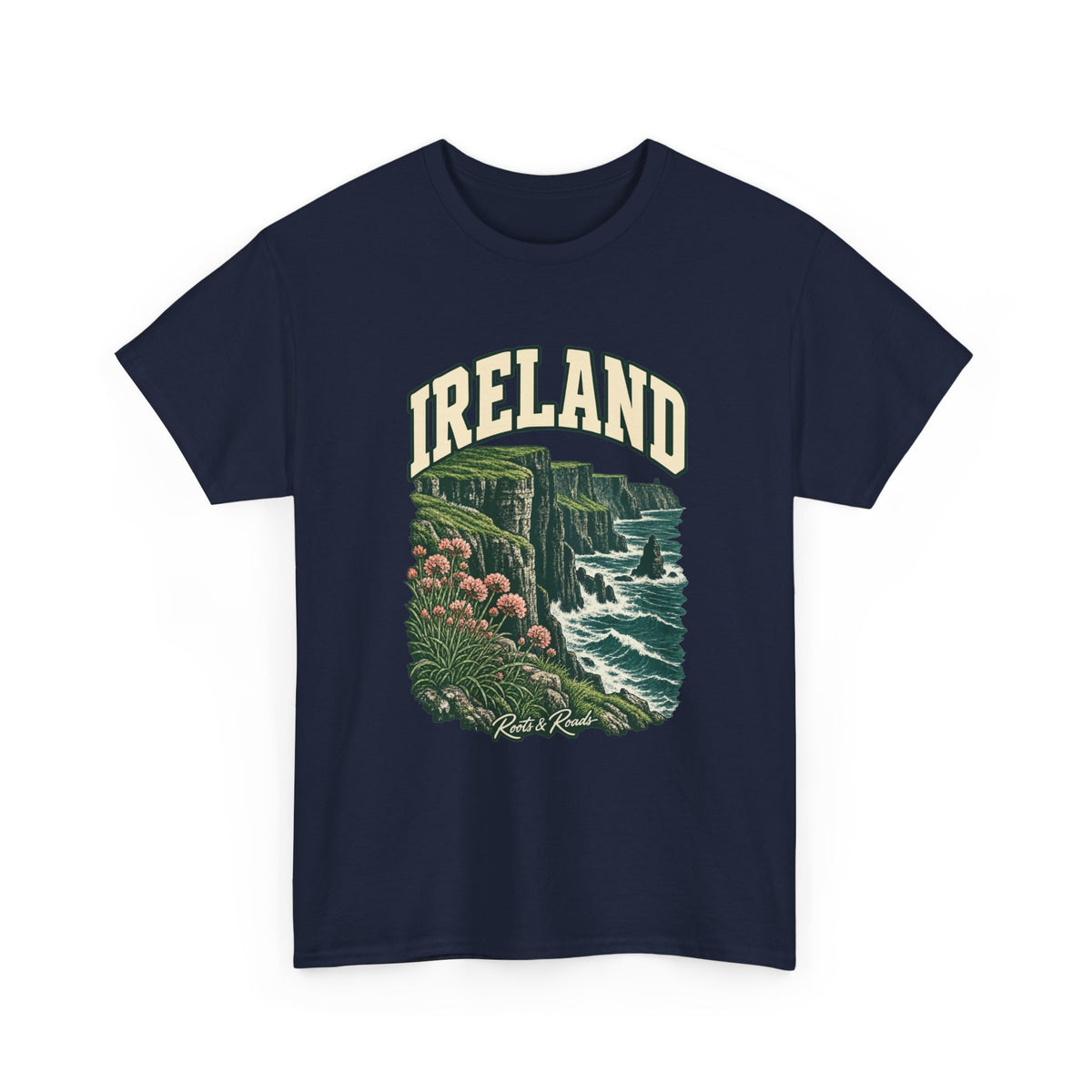 Front view of a Navy Gildan 5000 T-shirt with cream IRELAND lettering, green sea cliffs, Atlantic waves and pink coastal flowers, and Roots & Roads script.