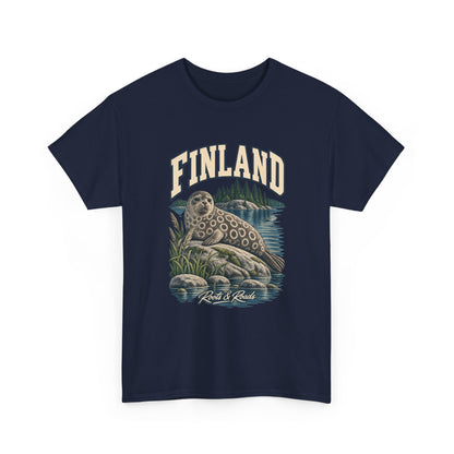 Front view of a Navy Gildan 5000 T-shirt with cream FINLAND lettering above a ringed seal, lake water, reeds and wooded islands, finished with Roots & Roads script.