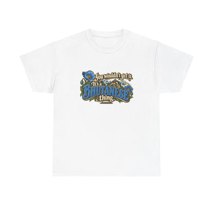 White Bhutan Bhutanese Thing T-shirt, flat front view with blue vintage lettering, cream script, blue poppies and a Himalayan monastery; “You wouldn’t get it. It’s a Bhutanese thing.”
