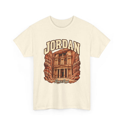 Front view of a Natural Gildan 5000 T-shirt with cream JORDAN lettering, a rock-cut stone facade and warm sandstone walls, and Roots & Roads script.