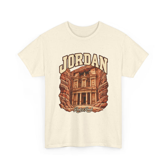 Front view of a Natural Gildan 5000 T-shirt with cream JORDAN lettering, a rock-cut stone facade and warm sandstone walls, and Roots & Roads script.
