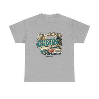 Front view of the Sport Grey Cuban Thing T-shirt with “You wouldn’t get it. It’s a Cuban thing.” oversized teal rounded lettering with cream outlines and ochre shadows, a vintage coral car, coastal road and palm trees.