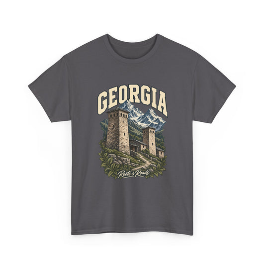 Front view of a Charcoal Gildan 5000 T-shirt with cream GEORGIA lettering above stone towers, snowy mountains, clustered buildings and a winding path, finished with Roots & Roads script.