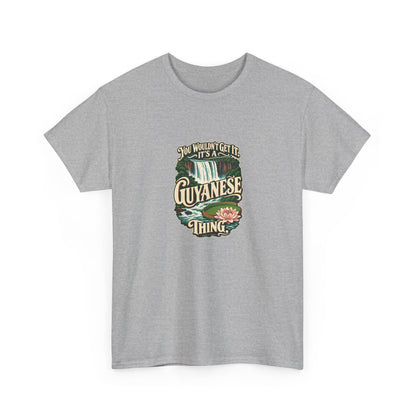 Guyana Guyanese Thing T-shirt in Sport Grey, shaped front view; cream vintage sign-painted lettering with a waterfall and tropical water lily and the quote “You wouldn’t get it. It’s a Guyanese thing.”