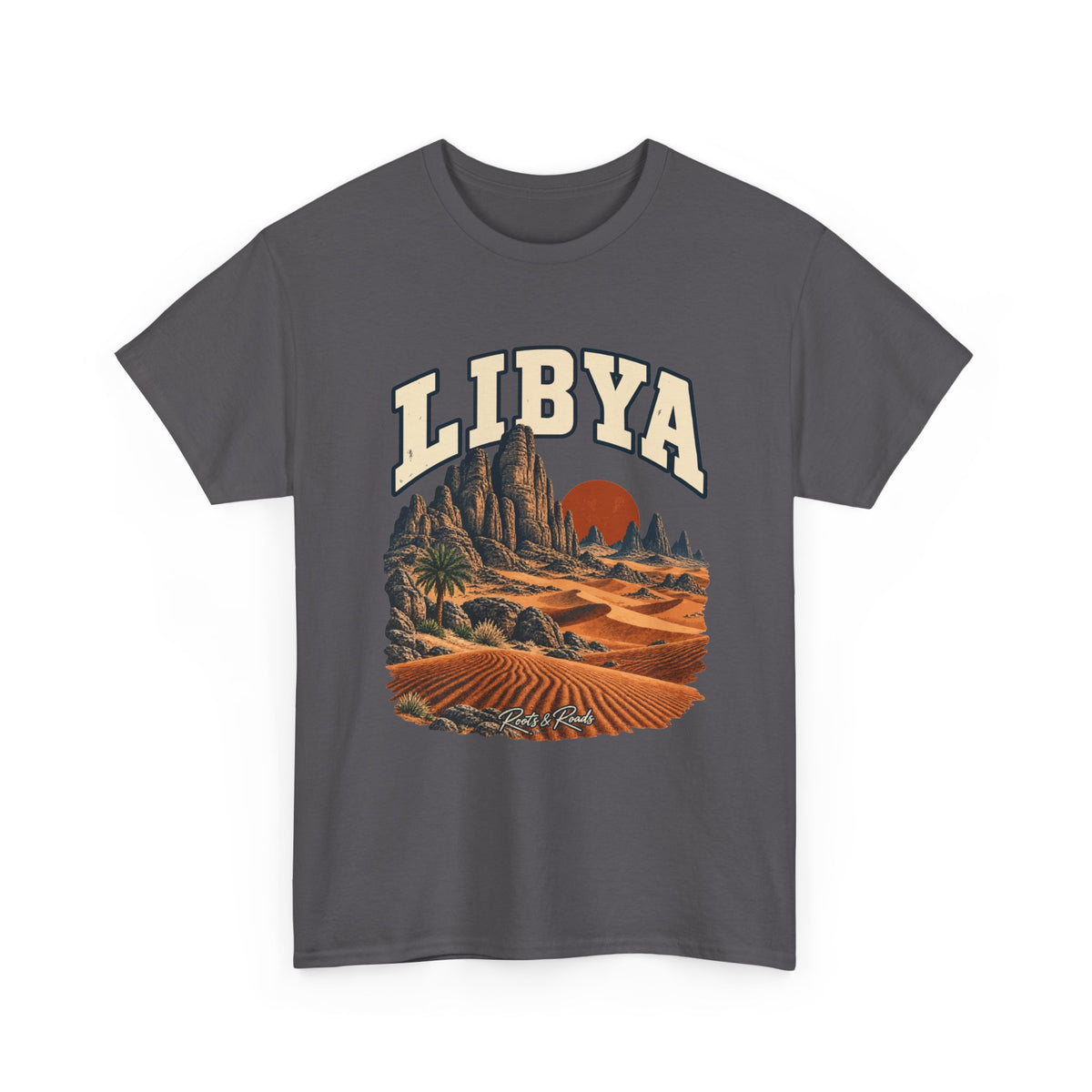 Front view of a Charcoal Gildan 5000 T-shirt with cream LIBYA lettering, sandstone spires, wind-shaped dunes, a lone palm and a rust-coloured sun, and Roots & Roads script.