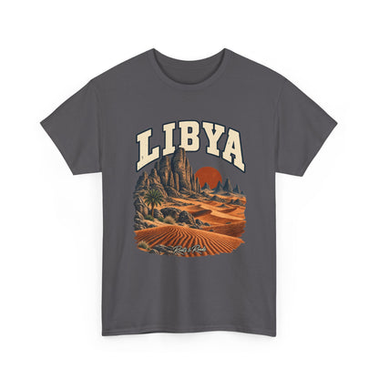 Front view of a Charcoal Gildan 5000 T-shirt with cream LIBYA lettering, sandstone spires, wind-shaped dunes, a lone palm and a rust-coloured sun, and Roots & Roads script.