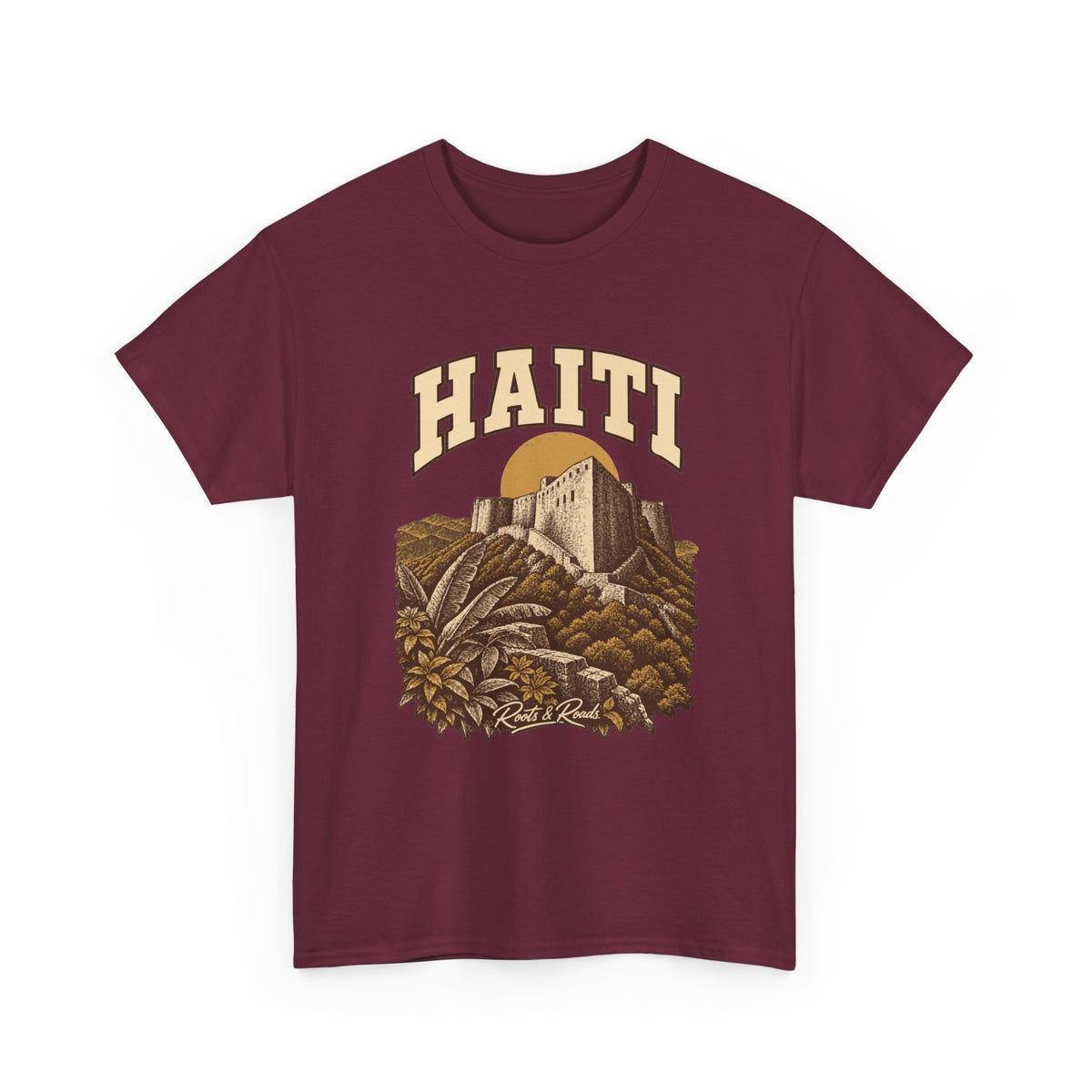 Front view of a Maroon Gildan 5000 T-shirt with cream HAITI lettering, a stone fortress, an ochre sun disc and layered hills, and Roots & Roads script.