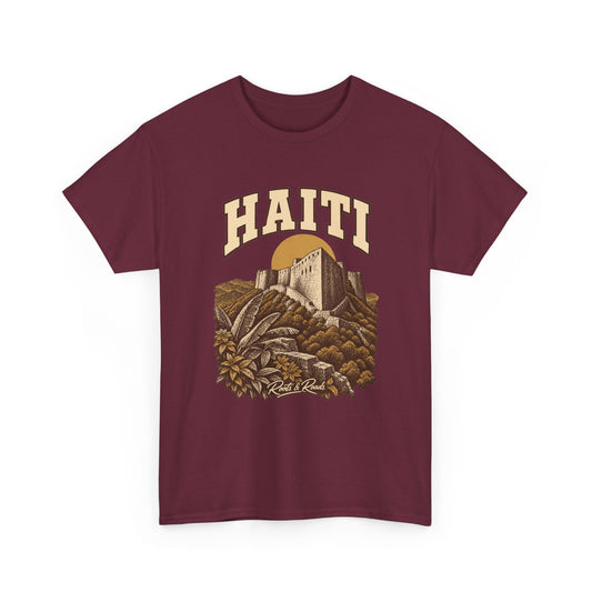 Front view of a Maroon Gildan 5000 T-shirt with cream HAITI lettering, a stone fortress, an ochre sun disc and layered hills, and Roots & Roads script.