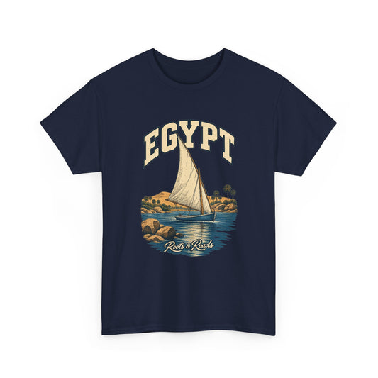 Front view of a Navy Gildan 5000 T-shirt with cream EGYPT lettering above a triangular-sailed boat, blue river water, palms and warm rocks, finished with Roots & Roads script.