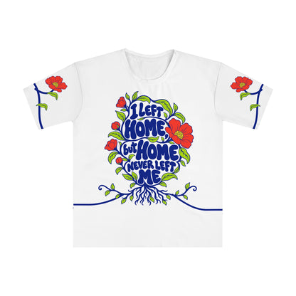 Front of the Roots & Roads “I left home, but home never left me” T-shirt with cobalt lettering, coral flowers, buds, lime leaves and roots on white.