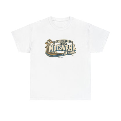 Front view of the White Motswana Thing T-shirt with “You wouldn’t get it. It’s a Motswana thing.” ivory athletic lettering with blue shadows, an integrated mokoro canoe, papyrus reeds and water lines.