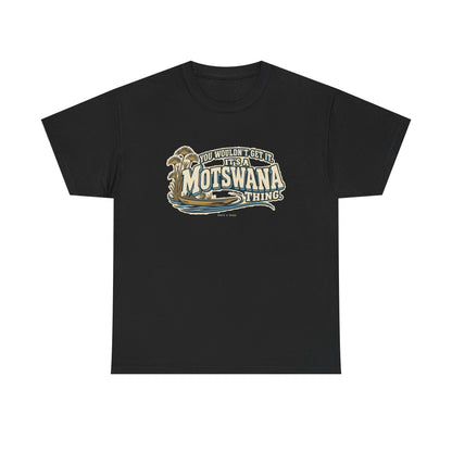 Front view of the Black Motswana Thing T-shirt with “You wouldn’t get it. It’s a Motswana thing.” ivory athletic lettering with blue shadows, an integrated mokoro canoe, papyrus reeds and water lines.