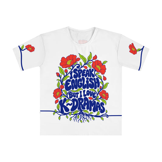 Front of the Roots & Roads “I speak English but I love K~dramas” T-shirt with cobalt lettering, coral flowers and lime foliage on white.