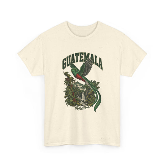 Front view of a Natural Gildan 5000 T-shirt with green GUATEMALA lettering above flying green-and-red quetzal, long tail plumes, waterfall, forest ravine and ferns, finished with Roots & Roads script.