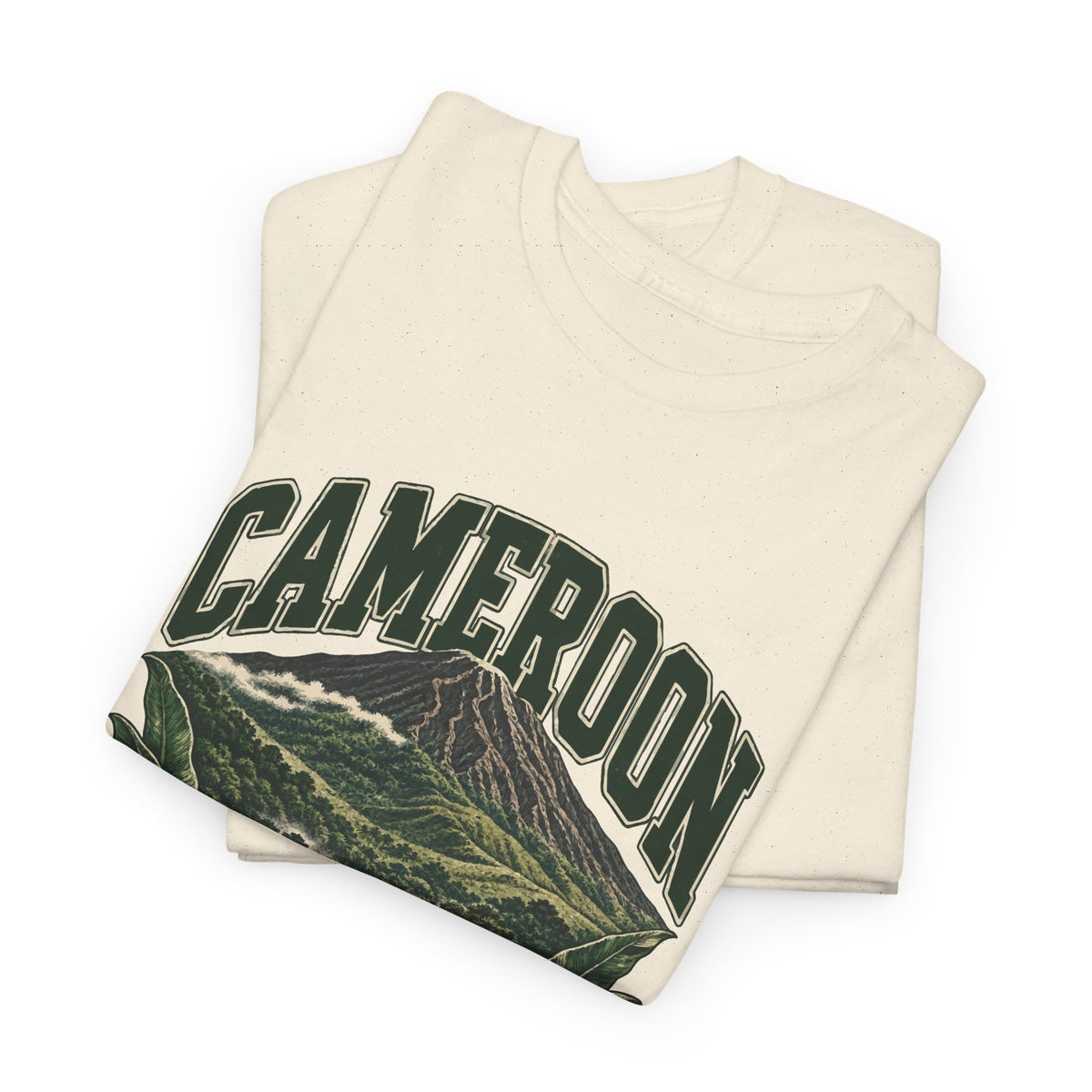 Folded Natural Cameroon Fresh Prints T-shirt showing green CAMEROON lettering above the upper slopes of a forested volcano.