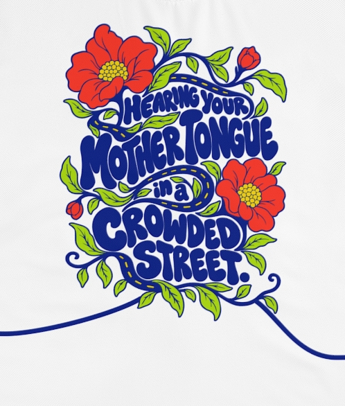 Actual supplier front-view detail of the wearer’s right sleeve on the Roots & Roads “Hearing your mother tongue in a crowded street.” T-shirt.