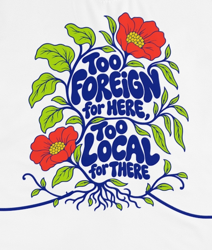 Actual supplier mockup detail of the Roots & Roads “Too foreign for here, too local for there” T-shirt’s botanical artwork.