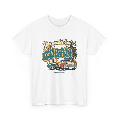 Alternate front view of the White Cuban Thing T-shirt with “You wouldn’t get it. It’s a Cuban thing.” oversized teal rounded lettering with cream outlines and ochre shadows, a vintage coral car, coastal road and palm trees.