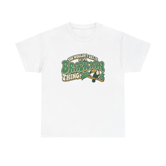 Front view of the White Brazilian Thing T-shirt with “You wouldn’t get it. It’s a Brazilian thing.” green bubble lettering with ivory outlines, ochre shadows and an integrated toucan on a leafy branch.