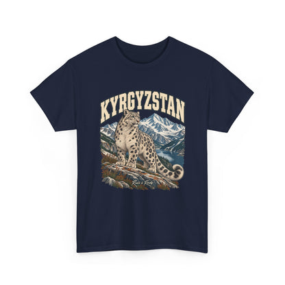 Front view of a Navy Gildan 5000 T-shirt with cream KYRGYZSTAN lettering, a snow leopard on a rocky ledge, a mountain lake and snowy peaks, and Roots & Roads script.