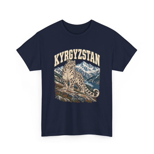 Front view of a Navy Gildan 5000 T-shirt with cream KYRGYZSTAN lettering, a snow leopard on a rocky ledge, a mountain lake and snowy peaks, and Roots & Roads script.