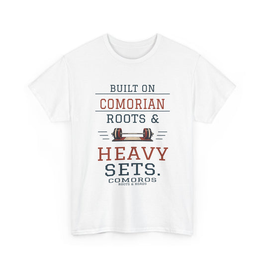 Comoros Heavy Sets Gym T-Shirt — White — front graphic with exact quote “Built on Comorian roots & heavy sets.”, Comoros label and Roots & Roads signature.