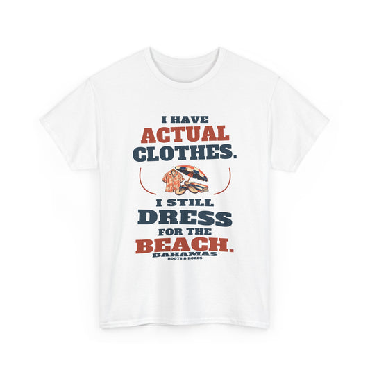 White Bahamas Beach Clothes T-Shirt, front view with oversized retro lettering reading “I have actual clothes. I still dress for the beach.”, illustrated beach clothes, Bahamas label and Roots & Roads signature.