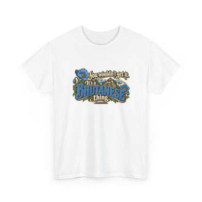 White Bhutan Bhutanese Thing T-shirt, shaped front view with blue vintage lettering, cream script, blue poppies and a Himalayan monastery; “You wouldn’t get it. It’s a Bhutanese thing.”