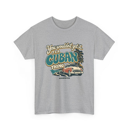 Alternate front view of the Sport Grey Cuban Thing T-shirt with “You wouldn’t get it. It’s a Cuban thing.” oversized teal rounded lettering with cream outlines and ochre shadows, a vintage coral car, coastal road and palm trees.