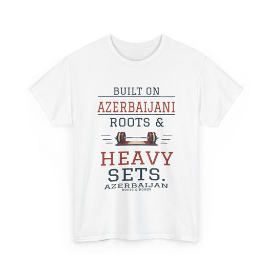 White Azerbaijan Heavy Sets Gym T-Shirt, front view: “Built on Azerbaijani roots & heavy sets.” in vintage varsity lettering with a barbell, Azerbaijan country label and Roots & Roads signature.