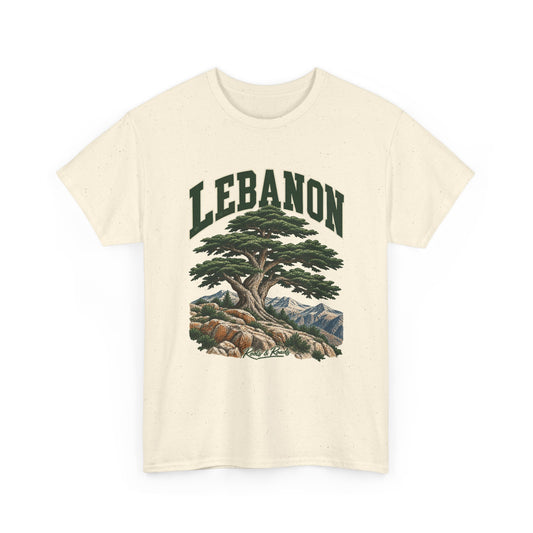 Front view of a Natural Gildan 5000 T-shirt with deep-green LEBANON lettering, a broad cedar, rocky ground and snowy mountain ridges, and Roots & Roads script.
