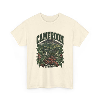 Front view of a Natural Gildan 5000 T-shirt with green CAMEROON lettering above a forested volcano, waterfall, red rocks and broad tropical leaves, finished with Roots & Roads script.