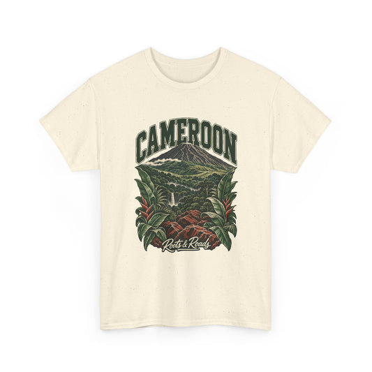Front view of a Natural Gildan 5000 T-shirt with green CAMEROON lettering above a forested volcano, waterfall, red rocks and broad tropical leaves, finished with Roots & Roads script.