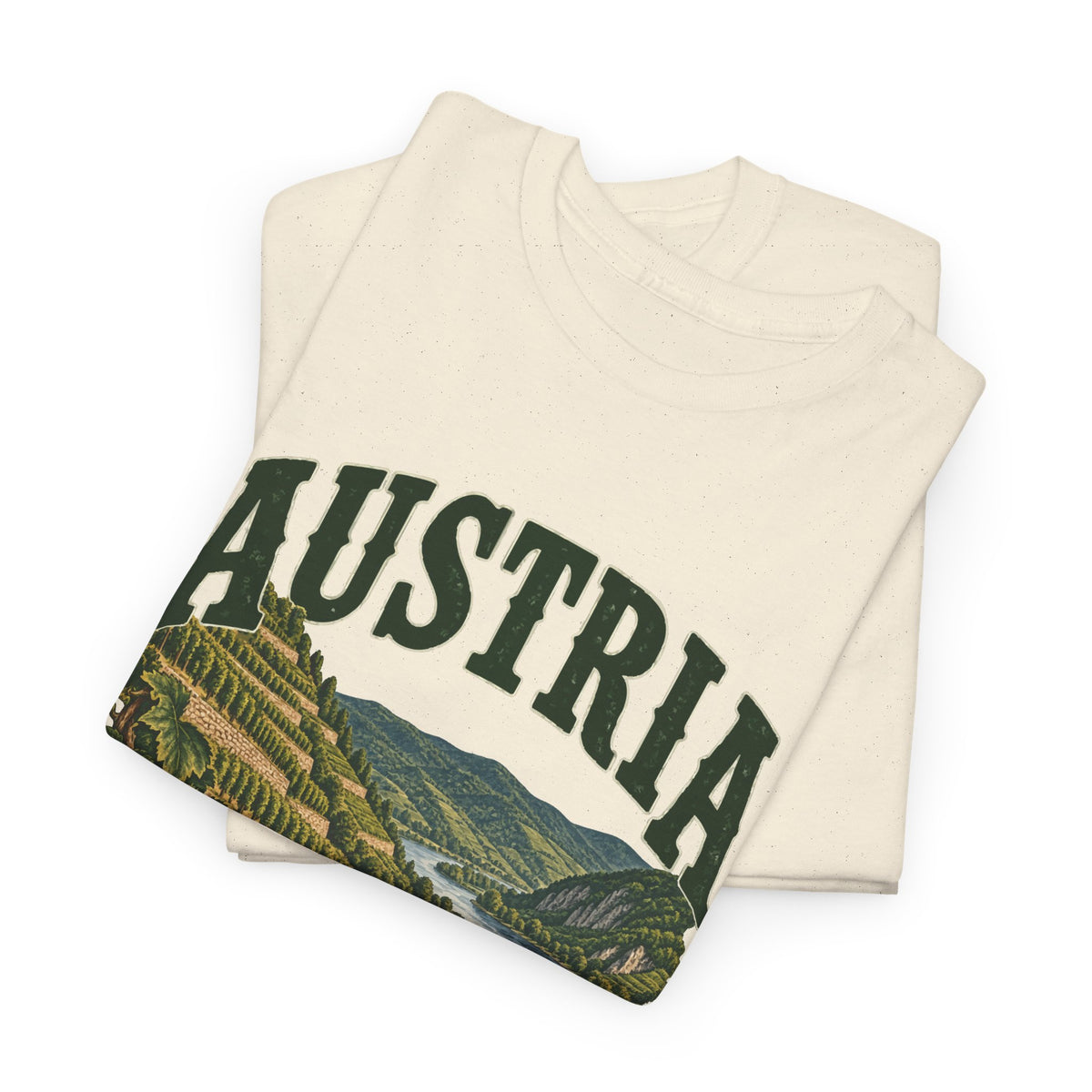 Folded Natural Austria Fresh Prints T-shirt showing green collegiate AUSTRIA lettering and the terraced-vineyard landscape.