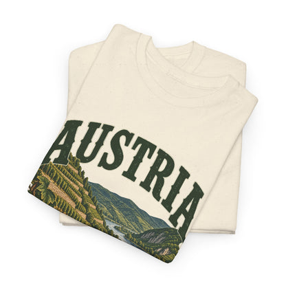 Folded Natural Austria Fresh Prints T-shirt showing green collegiate AUSTRIA lettering and the terraced-vineyard landscape.