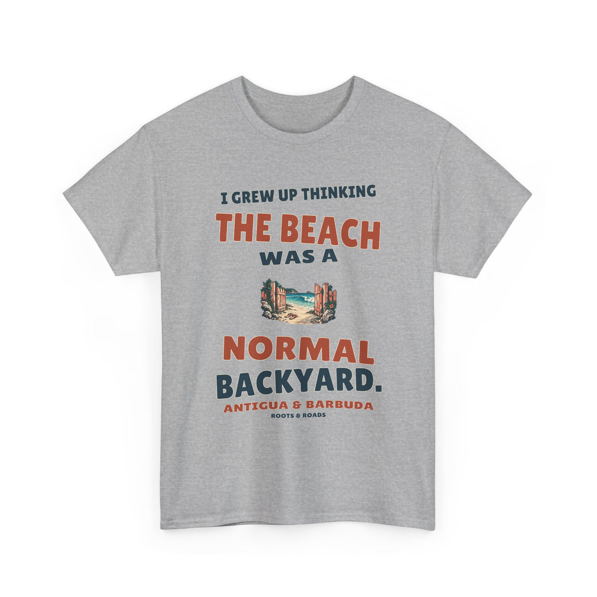 Sport Grey Antigua & Barbuda T-shirt, front view with vintage artwork reading “I grew up thinking the beach was a normal backyard.” and Roots & Roads signature.