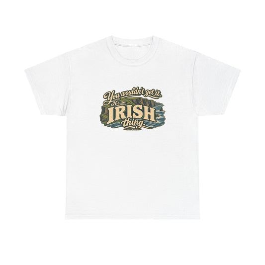 White Ireland Irish Thing T-shirt, flat front view with oversized cream lettering, flowing script, green cliffs and Atlantic waves; “You wouldn’t get it. It’s an Irish thing.”