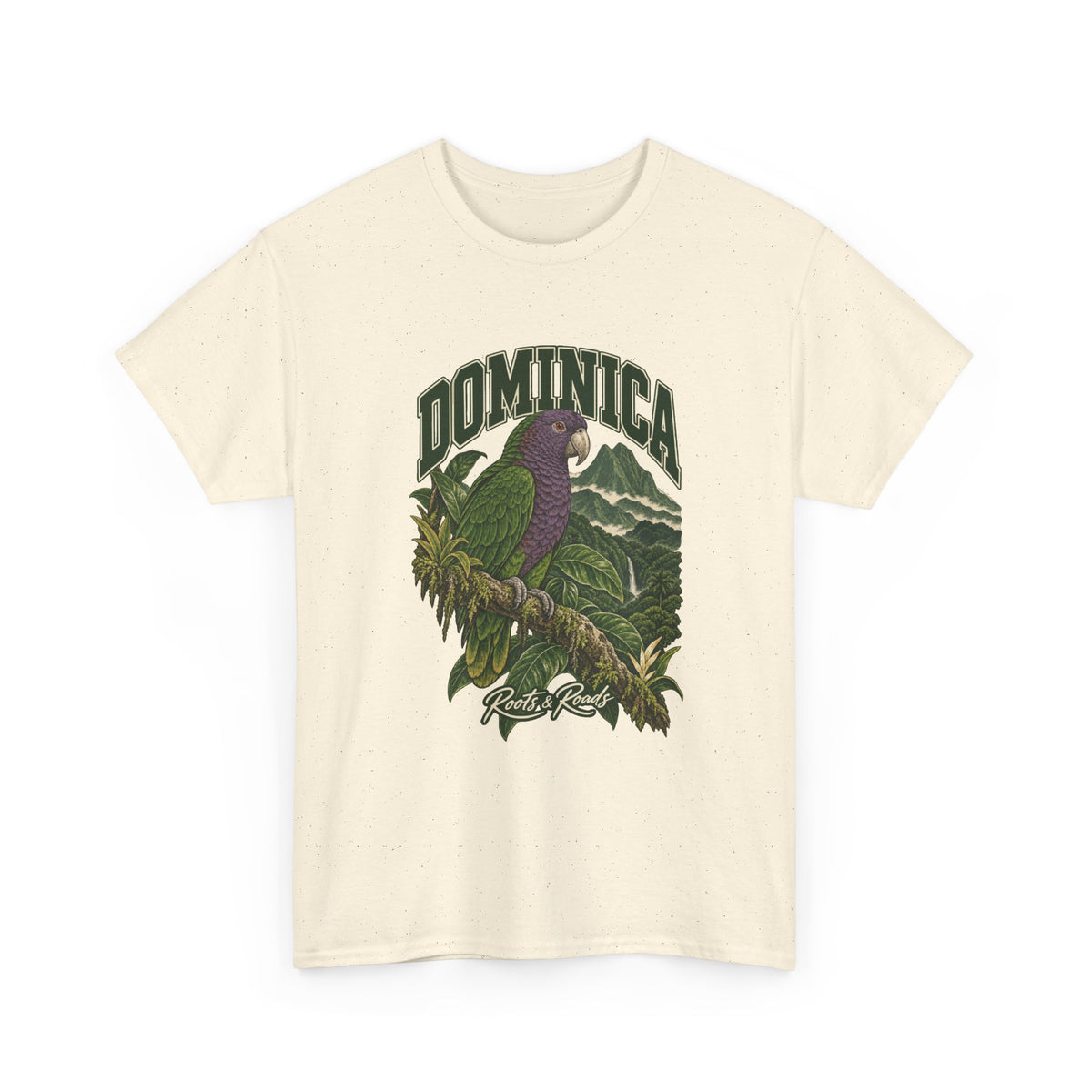 Front view of a Natural Gildan 5000 T-shirt with green DOMINICA lettering, a purple-and-green Sisserou parrot, rainforest leaves, misty mountains and Roots & Roads script.