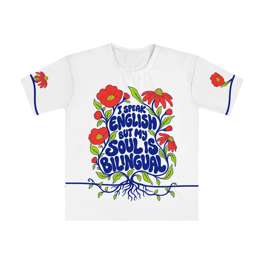 Front of the Roots & Roads “I speak English but my soul is bilingual” T-shirt with cobalt lettering, coral flowers and lime foliage on white.