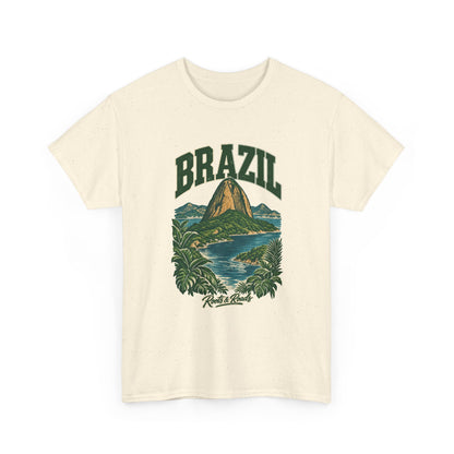 Front view of a Natural Gildan 5000 T-shirt with forest-green BRAZIL lettering, a Sugarloaf-inspired peak, blue bay water, tropical leaves and Roots & Roads script.